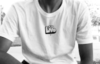 a young man wearing a white t - shirt